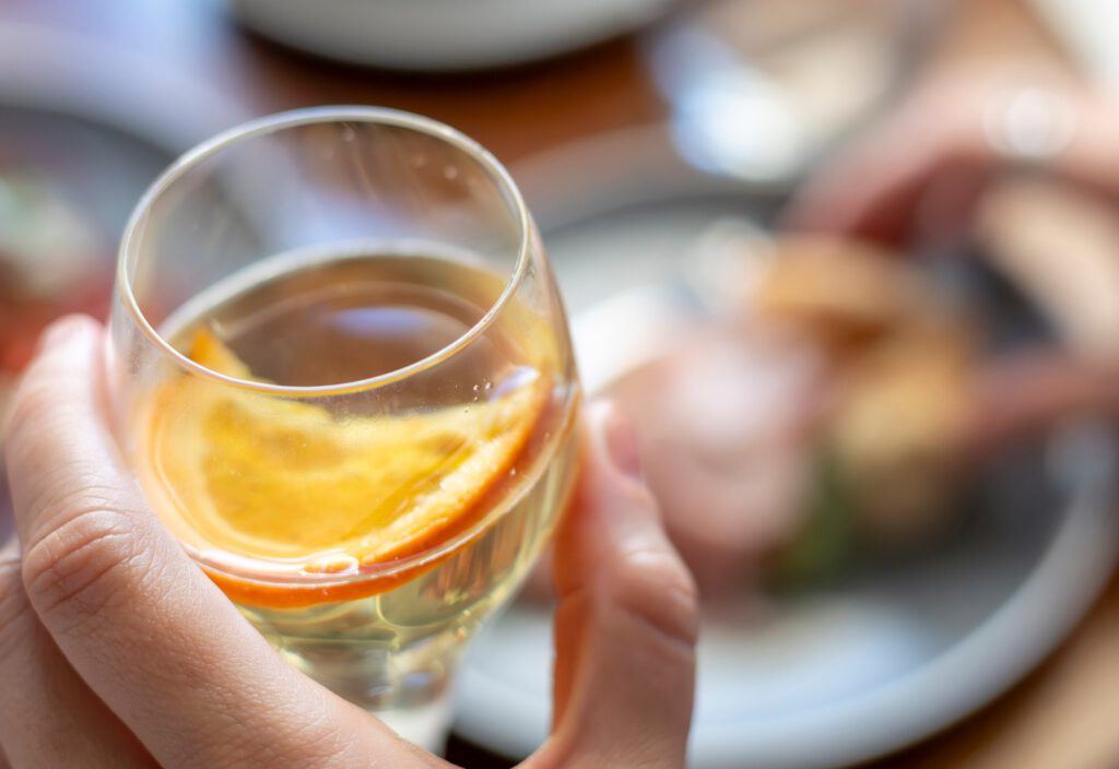 Glass of Italian prosecco with orange garnish at Bianco Italian restaurant in Caloundra