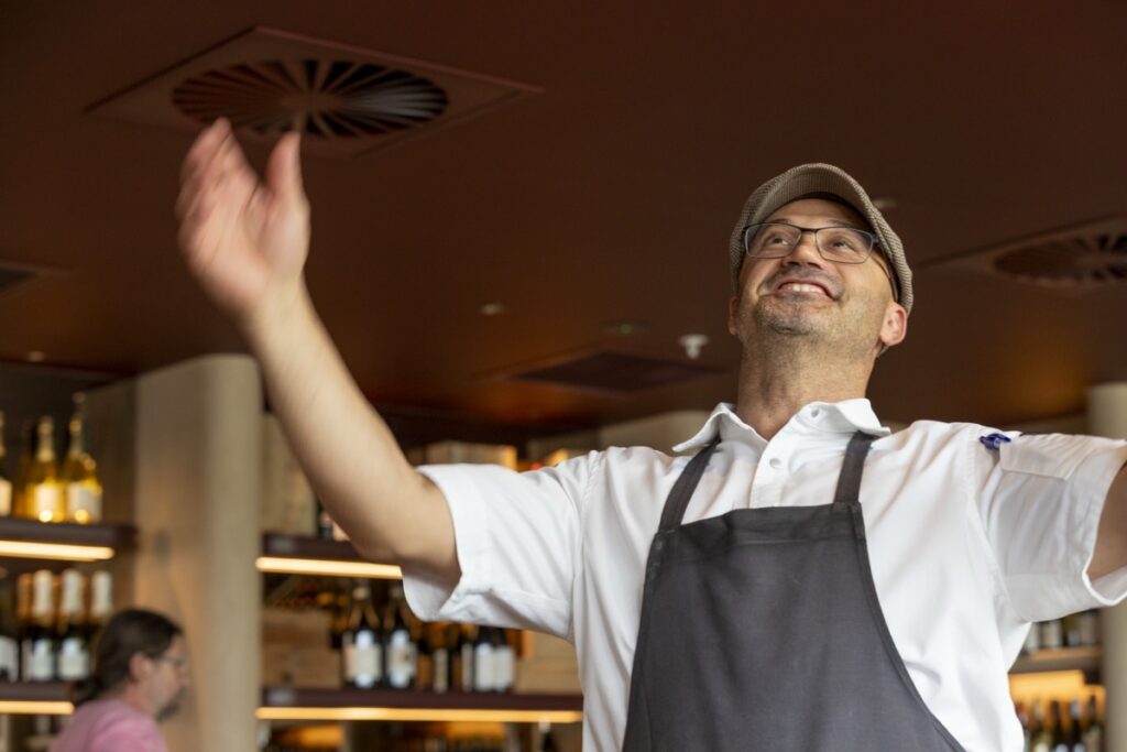 Smiling chef welcoming guests at Bianco Italian Restaurant Caloundra