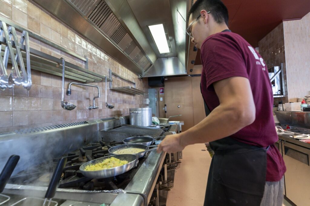 Chef cooking fresh pasta in pan at Bianco Italian Restaurant Caloundra