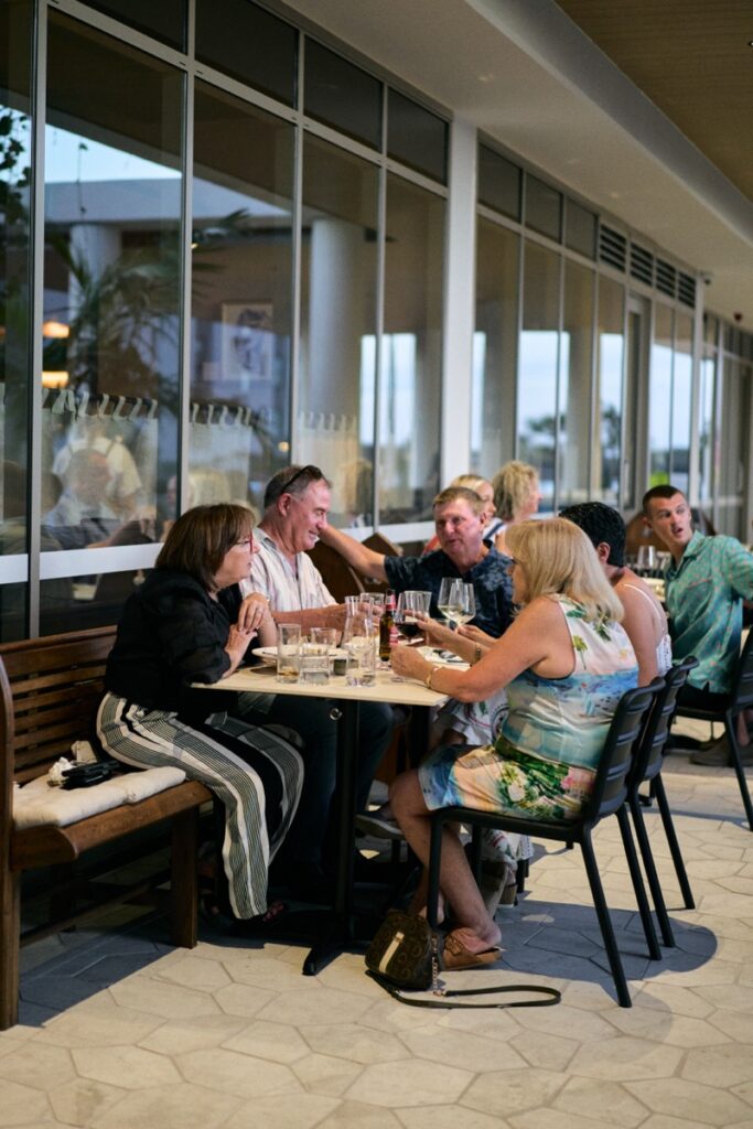 Group of guests enjoying dinner outdoors at Bianco Italian restaurant in Caloundra during opening night