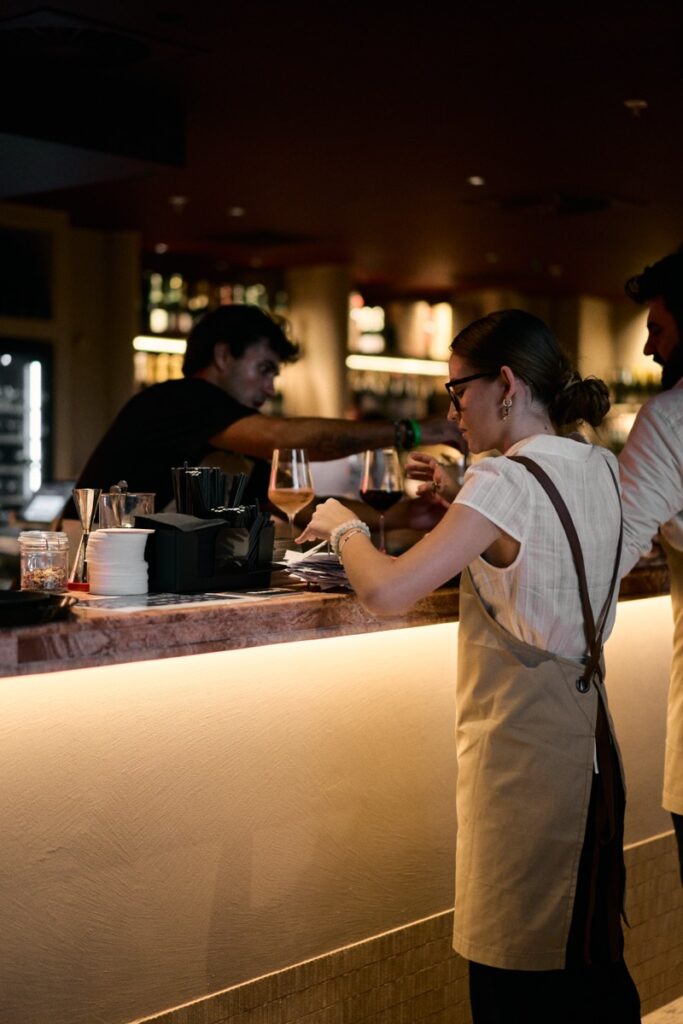 Woman ordering drinks at the bar during Bianco Italian opening night in Caloundra