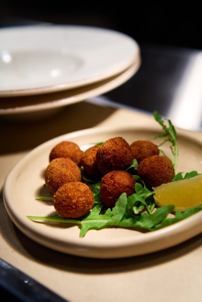 Arancini balls served on rocket with lemon wedge at Bianco Italian restaurant in Caloundra
