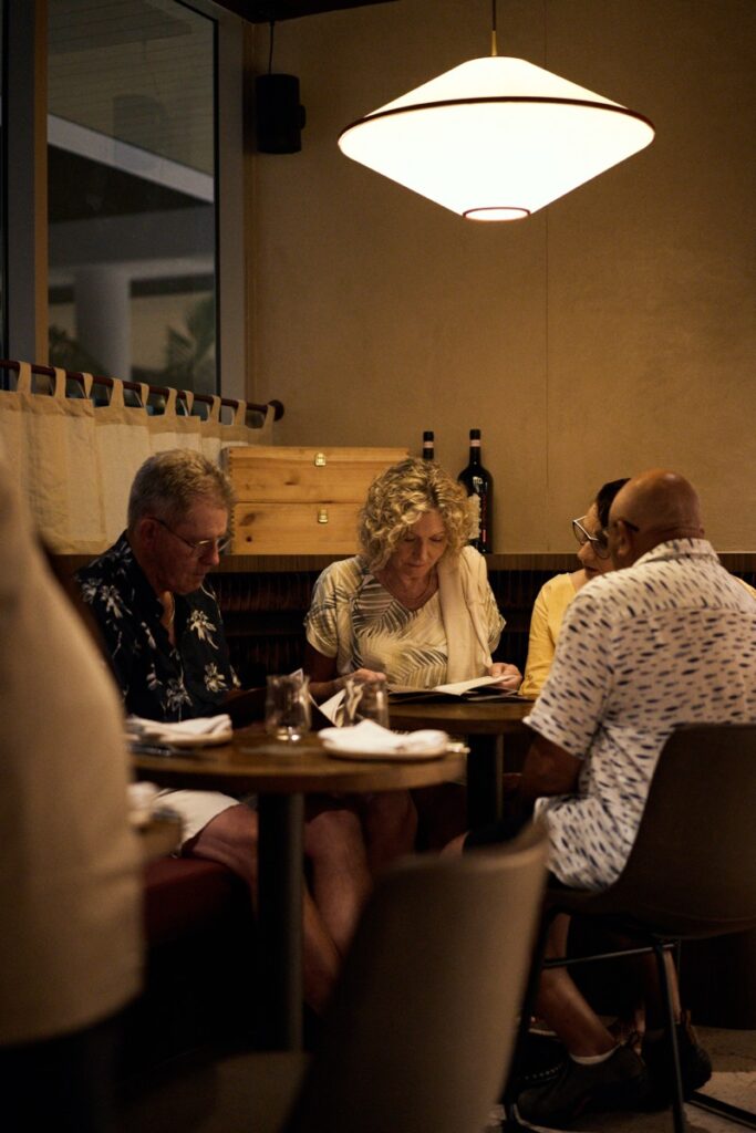 Guests dining at Bianco Italian restaurant in Caloundra enjoying dinner in a warm, modern Italian setting